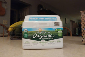 Happy Baby Organic Infant Formula container on a counter top