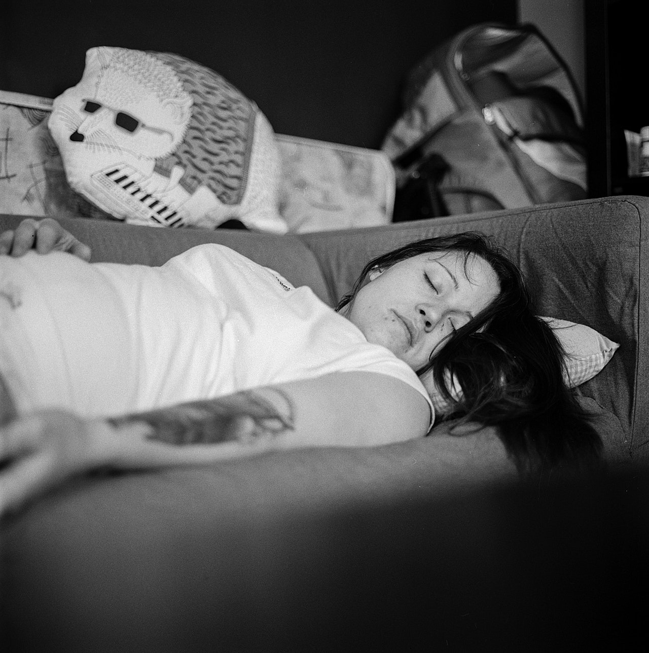 a woman laying on a couch, black and white photo