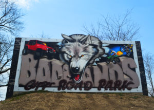 Badlands Off Road Park sign with large wolf on it