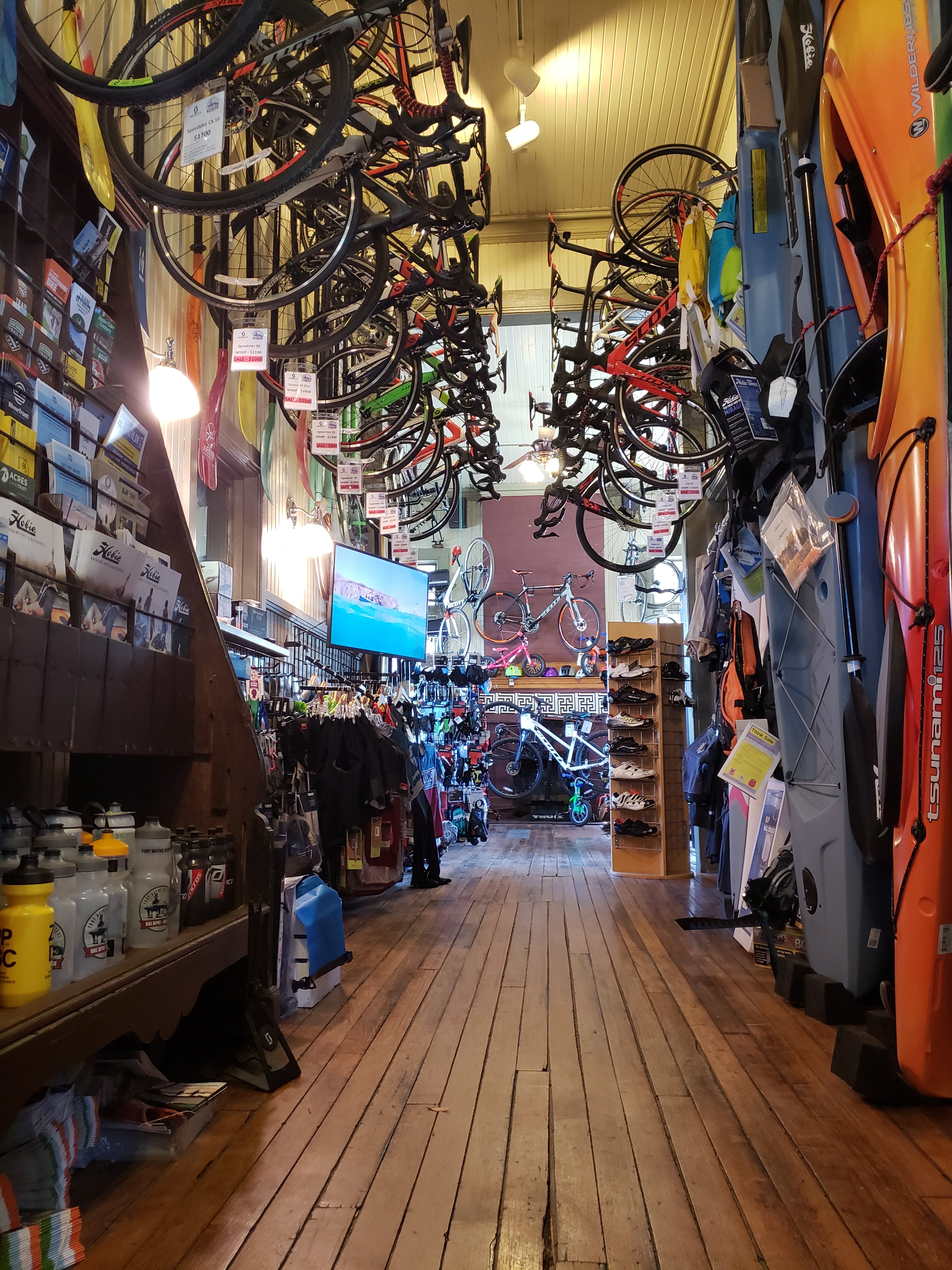 inside of Fort Wayne Outfitters, bikes hanging on the walls, kayaks leaning against the wall