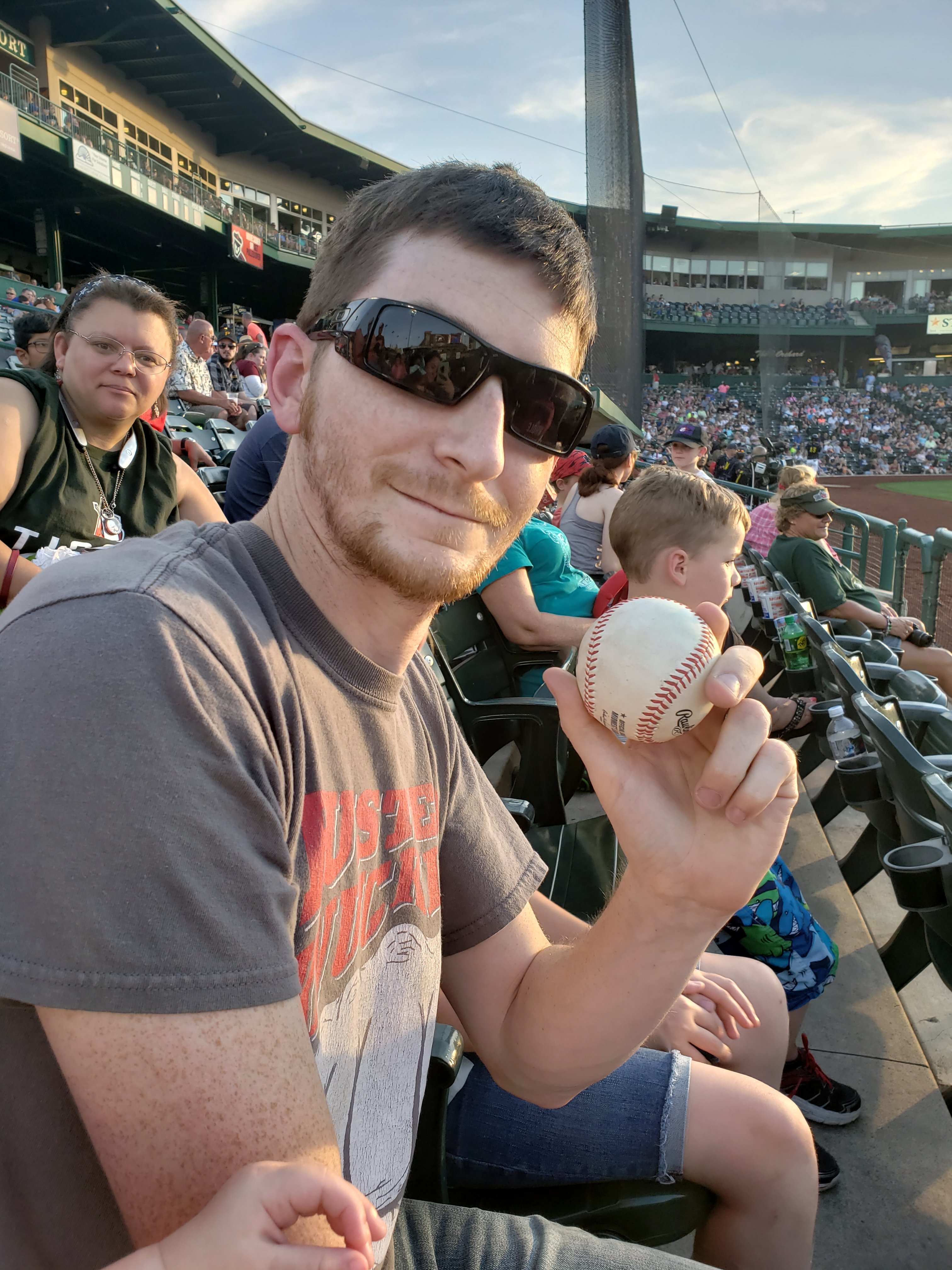 man holding a baseball in the ball stands