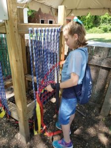 girl at a piece of playground equipment