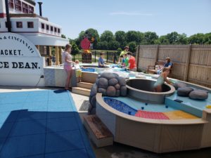 families playing outside in an outdoor play area