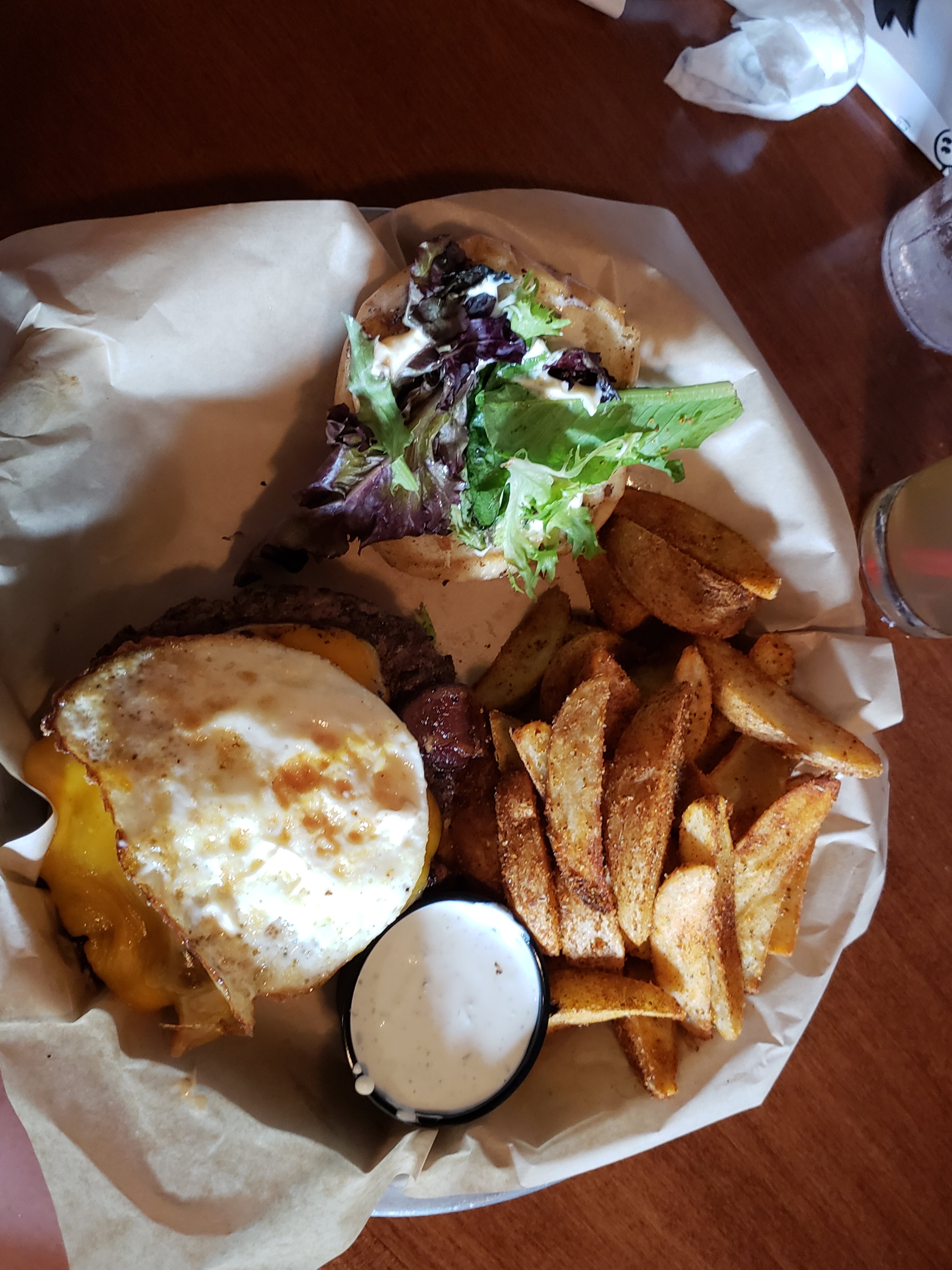 plate of food from Mad Anthony’s Brewery, potato wedges, dip, and the MAD, MAD, MAD burger