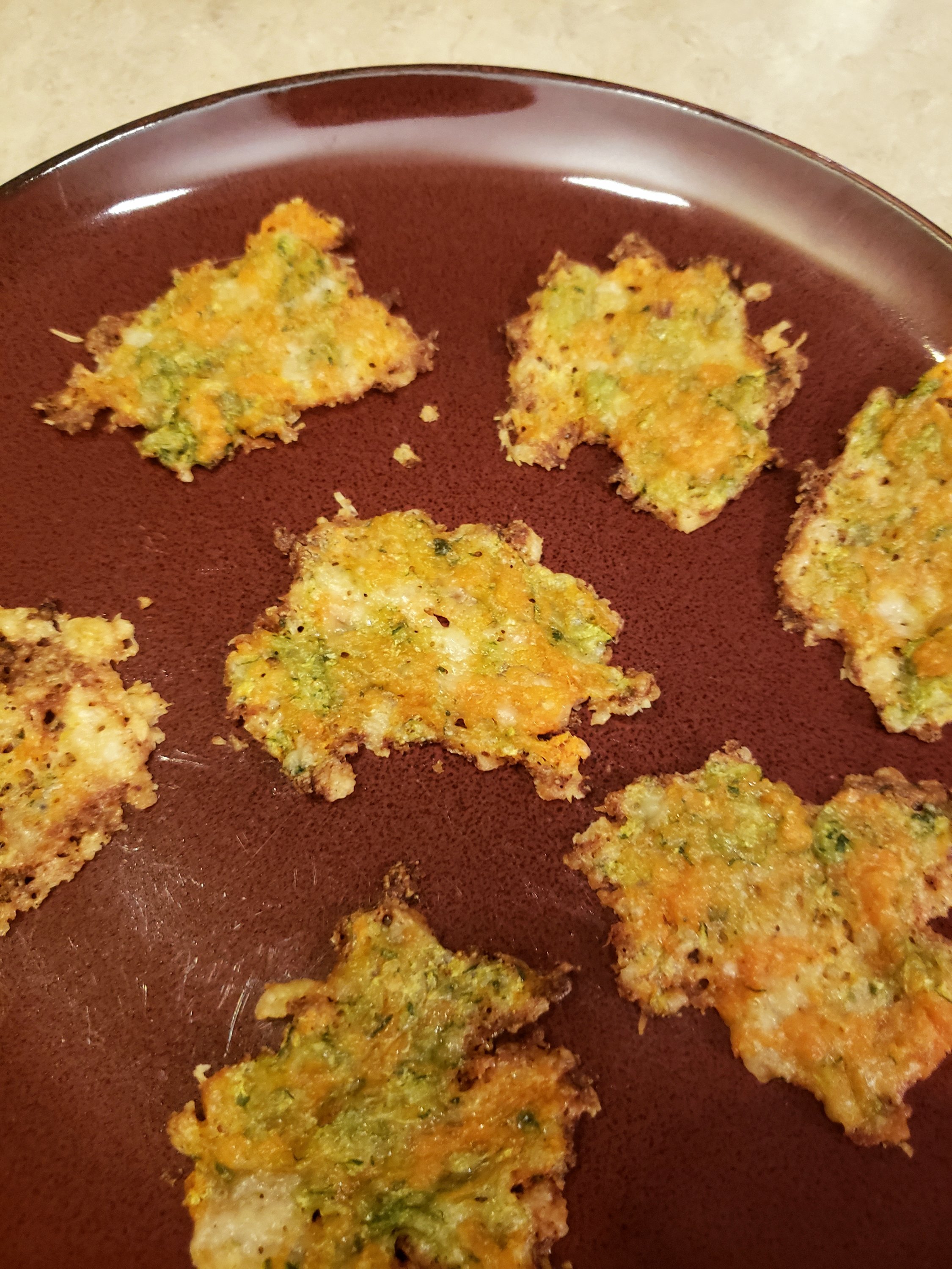 Parmesan Crisps on a reddish colored plate