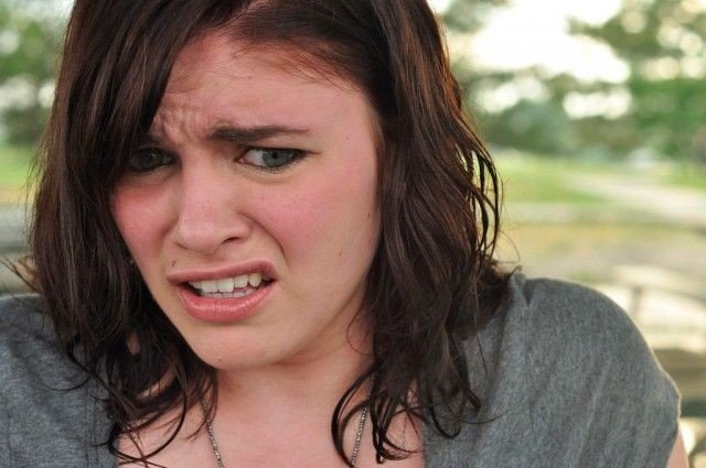 close up of a woman's face, she's making a funny face at the camera