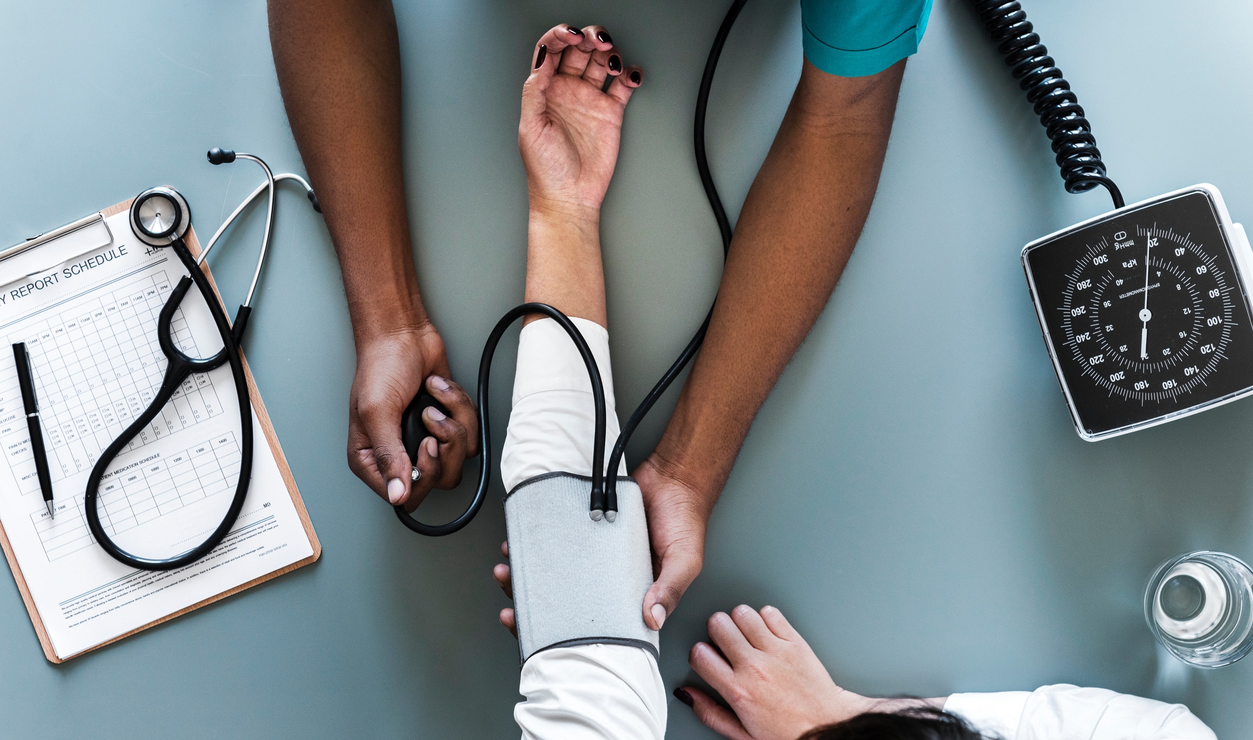 doctor taking someone's blood pressure