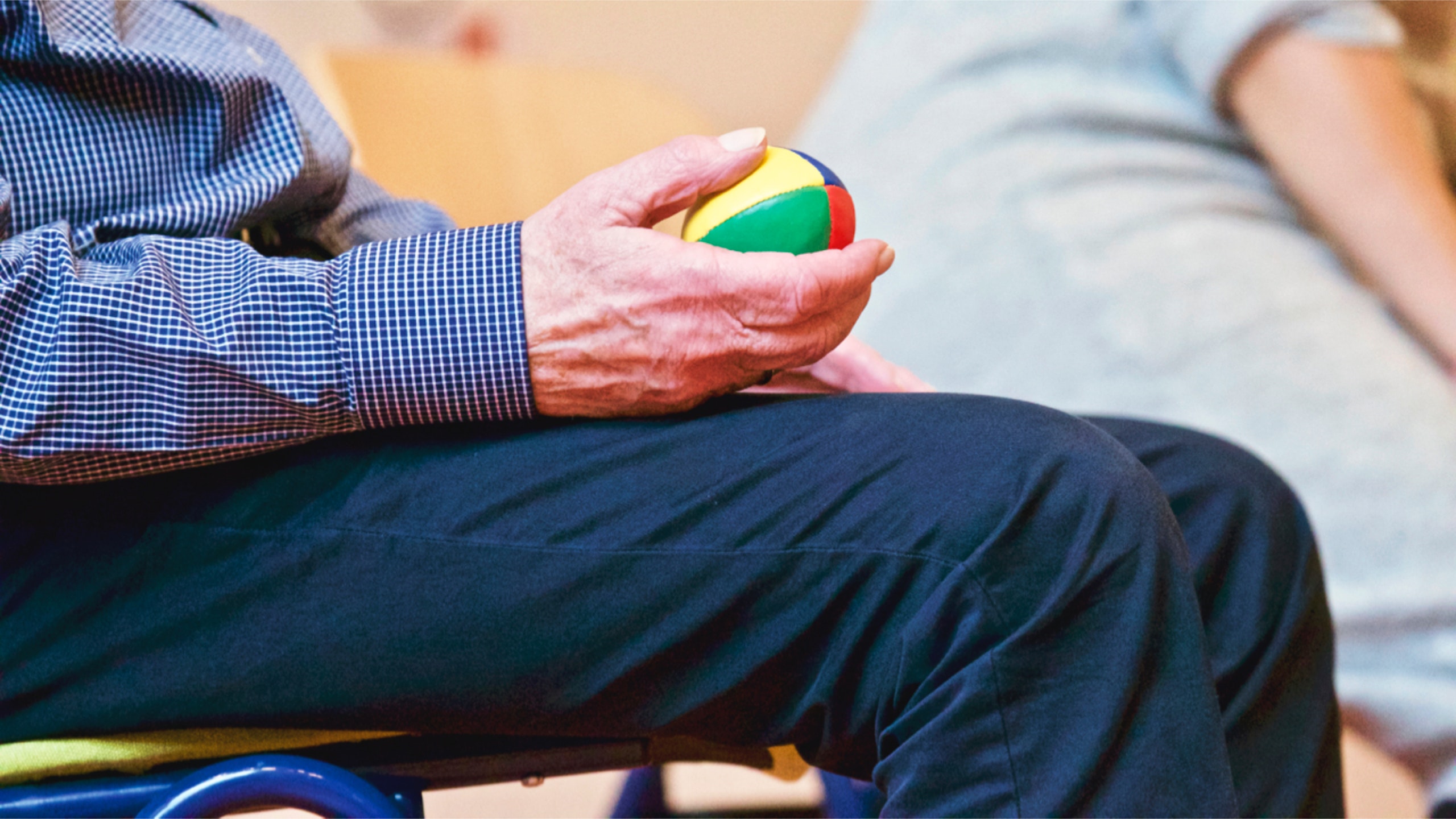 an older person holding a ball in their hand