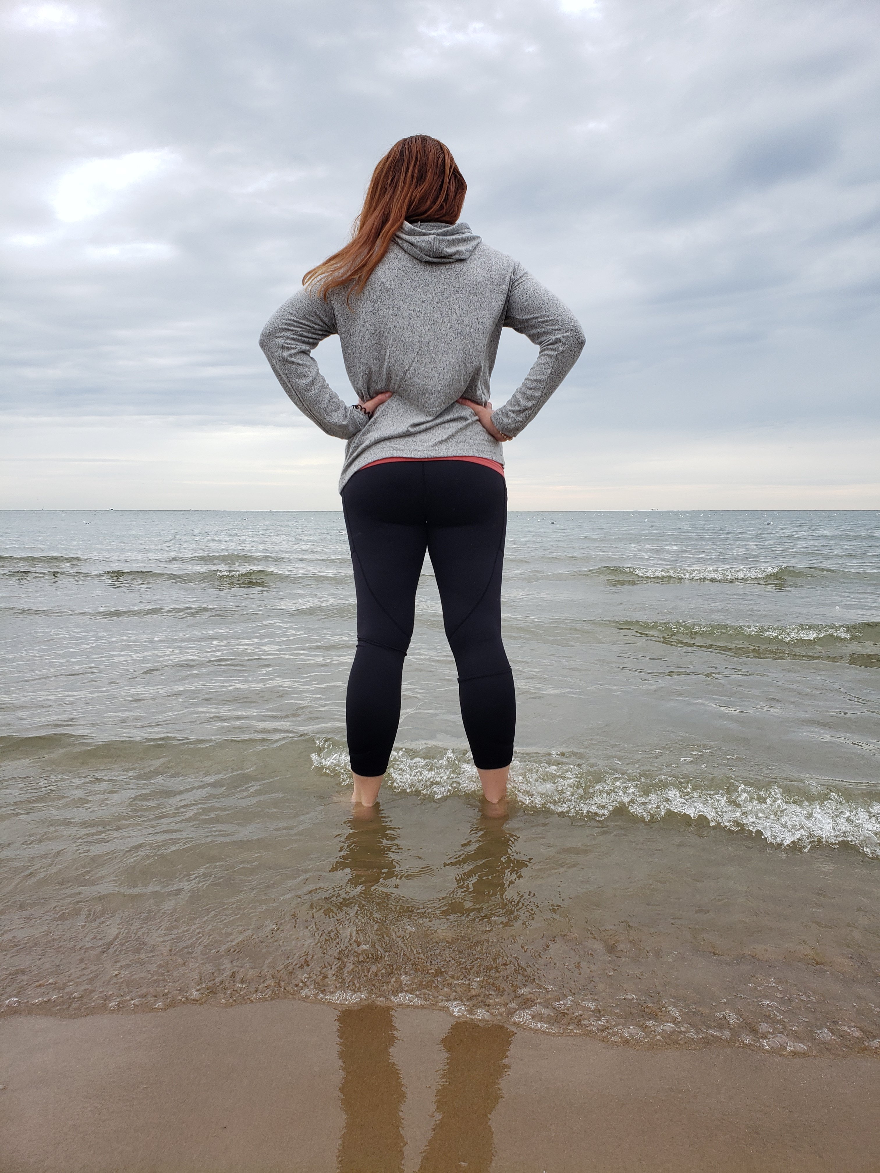 woman standing ankle deep in water  wearing comfortable clothes 